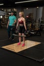 RUSSIA, MOSCOW - FEB 11, 2022: Instructor and client girl deadlift blonde trap bar personal exercise, for instructions Royalty Free Stock Photo