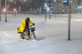 Employee, food deliverer from Yandex.Food rides an electric bike through the snow.