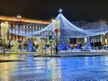 A tall Christmas tree with beautiful decorations and a large bright garland in Moscow