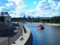 Russia, Moscow - July 2022: View of the Moscow Kremlin by a sunny cloudy day and Moscow transport: cars and a ship