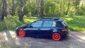 Russia, Moscow - June 01, 2019: Black Volkswagen Golf Mk6 tuned with ragtop and orange wheels. Stance tuning on air suspension in Royalty Free Stock Photo