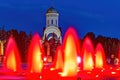 Fountains with red lights in Victory Park Poklonnaya Gora. Night illumination, summer evening in the city. Background - Church of Royalty Free Stock Photo