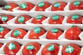 24.04.2021, Russia, Moscow. Large juicy varietal tomatoes with green labels on the side lie in a box