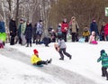 Russia,Moscow, Lianozovsky Park. Children and adults winter ride with slides in the Park.