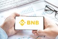 Russia Moscow 24.06.21 Logo of Binance coin in mobile phone. Cryptocurrency BNB token. Trading blockchain platform to