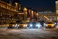 Night taxi and passenger cars traffic on the street covered by snow during blizzard Royalty Free Stock Photo
