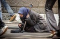 Russia Moscow. May 19, 2009 Foot pedestrians on the sidewalk and a homeless hungry beggar begging for alms.