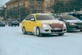 13.02.2021, Russia, Moscow. The yandex taxi car quickly drives through the snow-covered streets of the city.