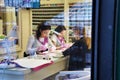 12.18.2018 Russia. Moscow. Nail master makes a manicure client. view through the glass.