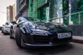 Russia Moscow 2019-06-17 New shiny luxury dark blue sports car Porsche 911 parked on street, front bottom view on bonnet