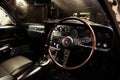 Classic Mazda Cosmo car interior with wooden steering wheel leather seats in retro garage photo Royalty Free Stock Photo