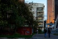 Russia, Moscow. Old empty five-story house on the background of a skyscraper. Men walking on a street