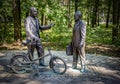 Bronze monument to nuclear scientists B. Pontecorvo with a bicycle and V. Dzhelepov.
