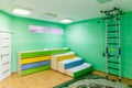 Russia, Moscow, 02.01.2019: Rest in a public kindergarten. Many beds in the bedroom. Empty room with green walls