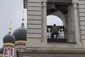 bell-ringer at work on belfry of Russian Orthodox church