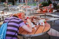 Russia. Moscow - SEPTEMBER 14, 2012 A man lonely sits near dirty tables with garbage near McDonald`s fast food