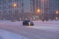 12.02.2021, Russia, Moscow. Snowfall and blizzard on the central streets of the city. Few cars, high snow on the roads, Royalty Free Stock Photo