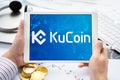 Russia Moscow 05.05.2021. Tablet with logo of cryptocurrency stock exchange Kucoin, China. Crypto coins company, service for