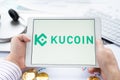 Russia Moscow 05.05.2021. Tablet with logo of cryptocurrency stock exchange Kucoin, China. Crypto coins company, service for