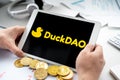 Russia Moscow 06.05.2021.Tablet with logo of Duckdao, platform with presale of new crypto coins, tokens. Blockchain cryptocurrency Royalty Free Stock Photo