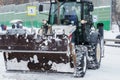 Russia Moscow 13.02.2021 Tractor, snow removal equipment. Street cleaning snow from road, sidewalk. City winter collapse