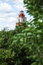 Russia. Murmansk lighthouse. Against the background of a blue sky with clouds, a view of the lighthouse. Memorial complex