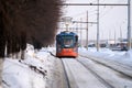 Russia, Naberezhnye Chelny, March 9, 2021: a tram rides on a snow-covered street. A woman in a medical mask is driving the tram