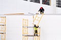 Russia, Naberezhnye Chelny, March 5, 2021: workers collect scaffolding on the facade of the building