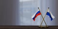 Russia and Navassa Island flags on table.