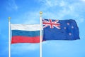 Russia and New Zealand two flags on flagpoles and blue cloudy sky