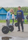 Russia Nikolskoe July 2016 competition for crossfit sporty girl in blue looks at the rod