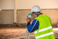 Surveyor work with a total station when building a factory