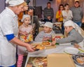 Group of children and teacher in cafe during cooking classes. Parents are watching