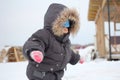 Russia, a boy child in warm clothes walks outside in the snow in winter Royalty Free Stock Photo