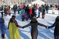 Cheerful people parents and children on the traditional Russian holiday Maslenitsa dance in a