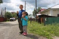 Russia, children boys eat ice cream on the street in the summer in the village of angry brothers