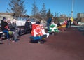 children play on the children`s playground with rides in the park on carousels with their parents