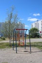 children`s swings in the courtyard of multi-storey buildings are empty without children Royalty Free Stock Photo