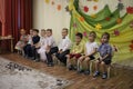 children sit on chairs in kindergarten boys and girls