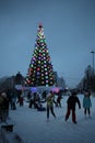city Christmas tree in the Park on the ice rink people ride fun for the holiday in the winter