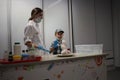 a girl scientist in a dressing gown shows a student experiments in the laboratory