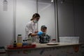 a girl scientist in a dressing gown shows a student experiments in the laboratory