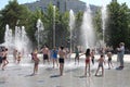 Russia, happy people and children bathe in the city fountain in the summer in the park water from the heat