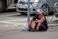 homeless woman asks for alms on the street
