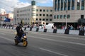 a man on a moped, an athlete in a helmet, rides on the highway in the city