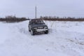 Offroad SUV `Suzuki Escudo` 4x4 goes fast on a snowy road in winter