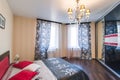 Russia, Novosibirsk - 07 May, 2016: interior room apartment. decorative elements, large beautiful bed in the bedroom, chandelier Royalty Free Stock Photo