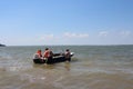 men swim in a motor boat in life jackets on a boat in the summer in the river