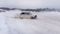 Russia, Novosibirsk - November 30, 2019. Russian low car `VAZ-Zhiguli` quickly goes in a skid on a winter road, turning the steeri