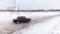 Russia, Novosibirsk - November 30, 2019. A Russian low-slung red VAZ-Zhiguli car goes fast sideways.